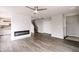 Open concept living room with fireplace, access to kitchen, and hardwood floors at 1305 W 23Rd St, Indianapolis, IN 46208