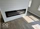 Bright living room featuring a modern electric fireplace and wood-style floors at 1305 W 23Rd St, Indianapolis, IN 46208