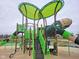 A colorful playground structure featuring slides, climbing features, and overhead coverings to help reduce sun exposure at 1704 N Winthrop Rd, Muncie, IN 47304