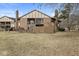 Condo's backyard with a well-maintained lawn, partial fence, and a screened-in porch at 2207 Rome Dr # B, Indianapolis, IN 46228