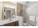 The bathroom boasts a large mirror with vanity lighting, single sink, and a shower-tub combo at 2207 Rome Dr # B, Indianapolis, IN 46228