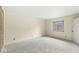 A carpeted bedroom with a window and closet to provide a comfortable living space at 2207 Rome Dr # B, Indianapolis, IN 46228