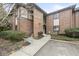 A charming brick condo with a sidewalk leading to the entrance and mature shrubbery at 2207 Rome Dr # B, Indianapolis, IN 46228