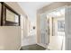 Hallway with neutral-colored walls, carpet flooring, and a view into the living room at 2207 Rome Dr # B, Indianapolis, IN 46228