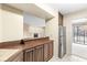 Kitchen featuring wood cabinets, stainless steel appliances, and a view to living room at 2207 Rome Dr # B, Indianapolis, IN 46228