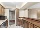 Open kitchen features wood cabinets, tile floors, and a view to the front entry at 2207 Rome Dr # B, Indianapolis, IN 46228