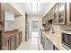Kitchen with tile flooring, wood cabinets, granite countertops and stainless steel appliances at 2207 Rome Dr # B, Indianapolis, IN 46228