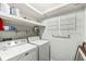 Laundry room with a washer, dryer, wire racks, and painted walls at 2207 Rome Dr # B, Indianapolis, IN 46228