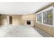Living room featuring a decorative fireplace and natural lighting from large windows at 2207 Rome Dr # B, Indianapolis, IN 46228