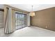 Carpeted living room featuring a sliding glass door to the exterior at 2207 Rome Dr # B, Indianapolis, IN 46228