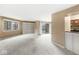 Open living room with built-in shelves, plush carpeting and a sliding glass door at 2207 Rome Dr # B, Indianapolis, IN 46228