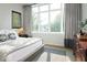 Comfortable bedroom features a large window with curtains and a dresser at 2719 Carrollton Ave, Indianapolis, IN 46205