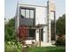 Modern home with stone accents, large windows, and a cozy outdoor seating area on the front lawn at 2719 Carrollton Ave, Indianapolis, IN 46205