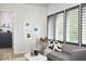 Cozy living room features a gray sofa with dog-themed pillows and modern decor at 2719 Carrollton Ave, Indianapolis, IN 46205