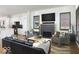 Open living room featuring fireplace, modern furnishings, and views into the bright, modern kitchen at 2719 Carrollton Ave, Indianapolis, IN 46205