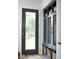 Stylish mudroom features black door and custom cabinetry with baskets for storage at 2719 Carrollton Ave, Indianapolis, IN 46205