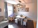 Bright dining area with modern lighting, bench seating, and a view of the backyard at 2847 Merts Dr, Indianapolis, IN 46237