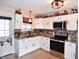 Bright kitchen featuring stainless steel appliances, white cabinets and a door to the outside at 2847 Merts Dr, Indianapolis, IN 46237