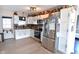 Well-lit kitchen featuring stainless steel appliances, white cabinets, laminate countertops, and a door to the outside at 2847 Merts Dr, Indianapolis, IN 46237