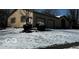 Attached two car garage of this single-Gathering home featuring a well-maintained lawn covered in snow at 296 Ironwood Ct, Carmel, IN 46033