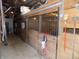 View of horse stalls in a barn showing rakes, shovels, and other equipment hanging from the wooden wall at 3060 N Alaska Rd, Cloverdale, IN 46120