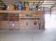 Interior horse barn with storage above the stalls, and various farm tools hanging from the wooden walls at 3060 N Alaska Rd, Cloverdale, IN 46120
