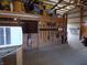 Horse barn interior with tools hanging on wooden wall and stalls along the side at 3060 N Alaska Rd, Cloverdale, IN 46120