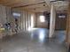 Spacious unfinished basement with a spiral staircase and natural light coming through the window at 3060 N Alaska Rd, Cloverdale, IN 46120