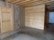Unfinished basement featuring a wooden plank wall with a door and a separate door next to it at 3060 N Alaska Rd, Cloverdale, IN 46120