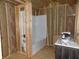Unfinished bathroom features a tub-shower and a sink with an unfinished stud wall surrounding it at 3060 N Alaska Rd, Cloverdale, IN 46120