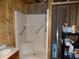 Unfinished bathroom with a new shower featuring grab bars next to some items on a black shelf at 3060 N Alaska Rd, Cloverdale, IN 46120