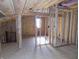 View of a bedroom under construction with insulation, electrical wiring, window and staircase in view at 3060 N Alaska Rd, Cloverdale, IN 46120