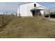 Exterior view of the white house with an outside picnic table and seating area at 3060 N Alaska Rd, Cloverdale, IN 46120