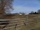 View of the property with a fence in the foreground and buildings in the background at 3060 N Alaska Rd, Cloverdale, IN 46120