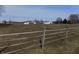 View of the property with a fence in the foreground and buildings in the background at 3060 N Alaska Rd, Cloverdale, IN 46120