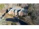 Aerial view of a brick home with gray roof, landscaped front yard, and long paved driveway at 3370 Walnut Creek Ct, Carmel, IN 46032