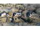 Aerial view of a brick home, located on a large lot with mature trees and a pond nearby at 3370 Walnut Creek Ct, Carmel, IN 46032