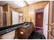 Well-lit bathroom with a marble countertop, wood cabinets, and decorative wallpaper at 3370 Walnut Creek Ct, Carmel, IN 46032