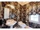 Elegant powder room features patterned wallpaper, white fixtures, and a decorative mirror at 3370 Walnut Creek Ct, Carmel, IN 46032