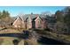 Aerial view of a brick home with a grey roof, landscaped front yard, and long paved driveway at 3370 Walnut Creek Ct, Carmel, IN 46032