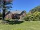Charming brick home with lush landscaping and a well-manicured lawn at 3370 Walnut Creek Ct, Carmel, IN 46032