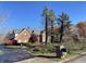 Lovely brick home with manicured landscaping, trees, and paved driveway and brick mailbox at 3370 Walnut Creek Ct, Carmel, IN 46032