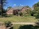 Beautiful brick home with a manicured lawn and mature landscaping on a sunny day at 3370 Walnut Creek Ct, Carmel, IN 46032