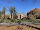 Beautiful brick home with a landscaped front yard featuring mature trees and colorful foliage at 3370 Walnut Creek Ct, Carmel, IN 46032