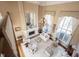 Elevated view of living room with fireplace, tall windows, chandelier and elegant furnishings at 3370 Walnut Creek Ct, Carmel, IN 46032