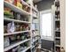 Walk-in pantry with ample shelving to store food and other kitchen supplies at 3370 Walnut Creek Ct, Carmel, IN 46032