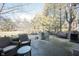 Stone patio with outdoor seating and a built-in grill, surrounded by lush landscaping at 3370 Walnut Creek Ct, Carmel, IN 46032