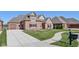 A stylish brick home showcasing a long drive and two-car garage, plus a well-manicured lawn at 4248 Stone Lake Dr, Zionsville, IN 46077