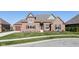Attractive brick home featuring a well-kept lawn, black shutters, and a two-car garage, inviting curb appeal at 4248 Stone Lake Dr, Zionsville, IN 46077