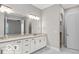Bright bathroom with marble floors, granite counters, dual sinks, and a large mirror at 4248 Stone Lake Dr, Zionsville, IN 46077
